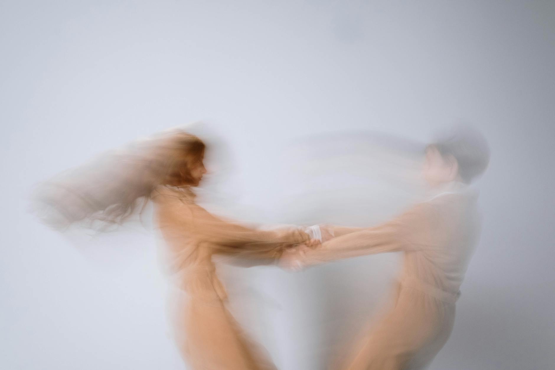 blurry photo of girl and boy spinning