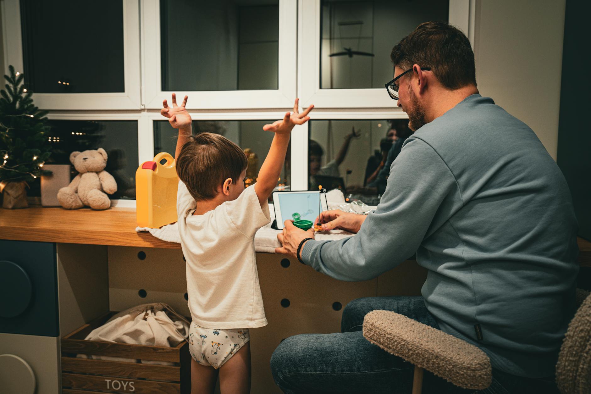 father and child bonding during evening time indoors