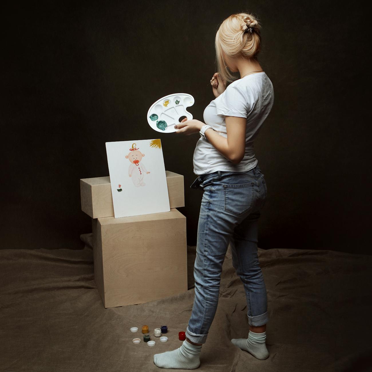 woman painting baby