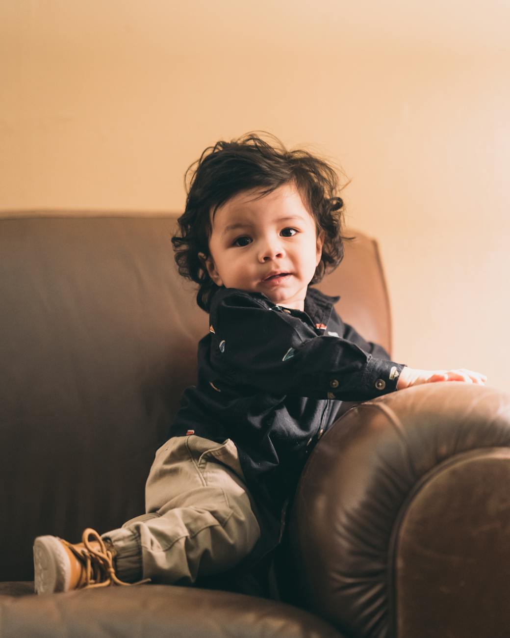 toddler on brown sofa
