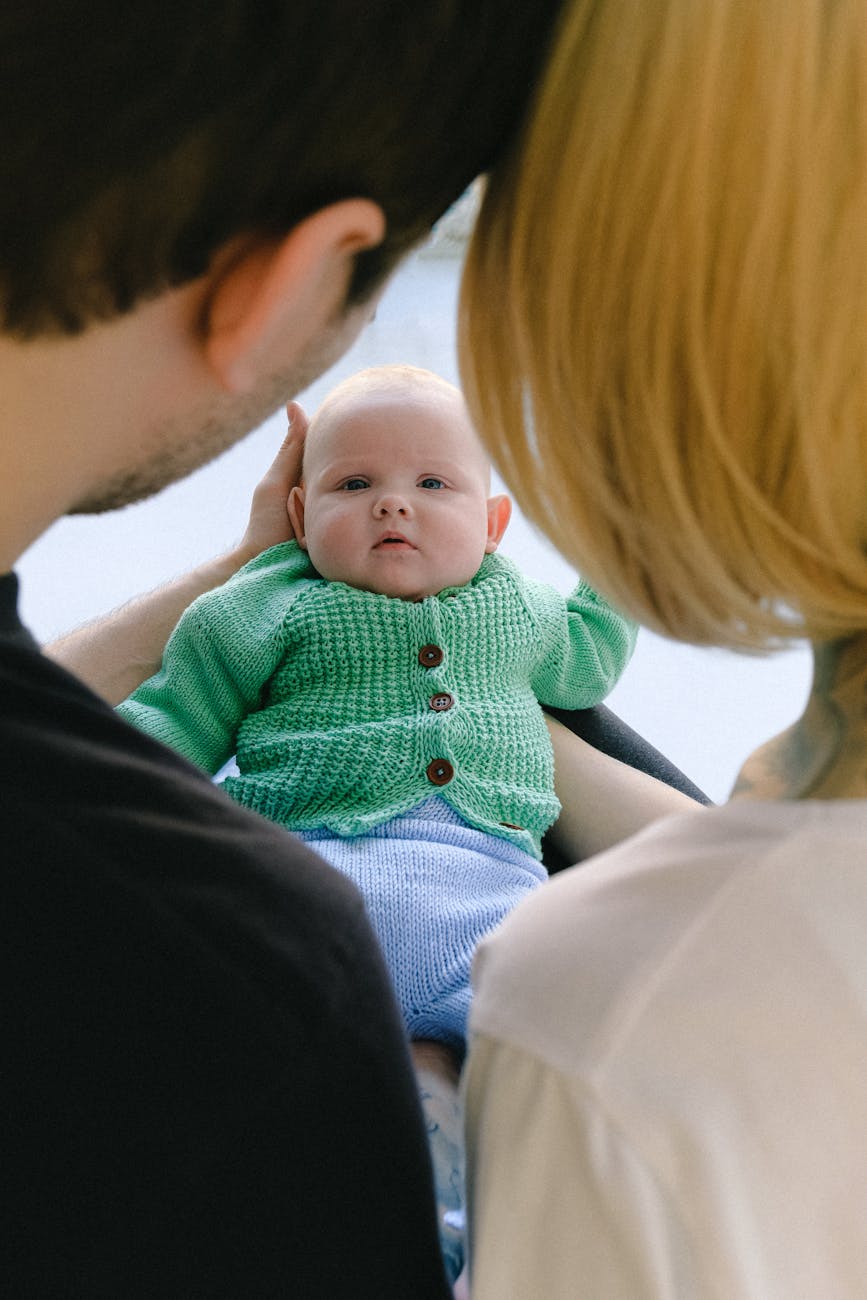 man in black shirt carrying baby