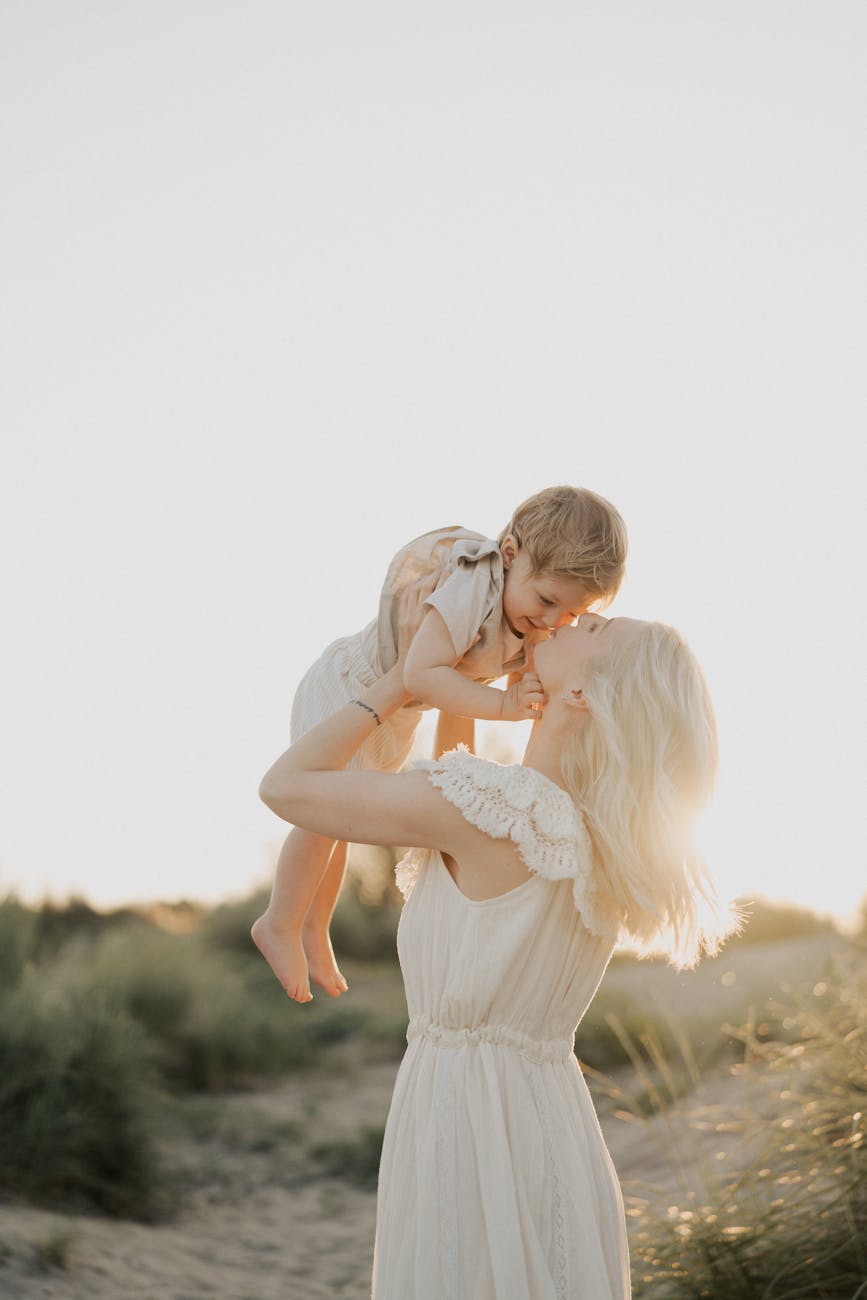 mother and child in sunset embrace on the beach