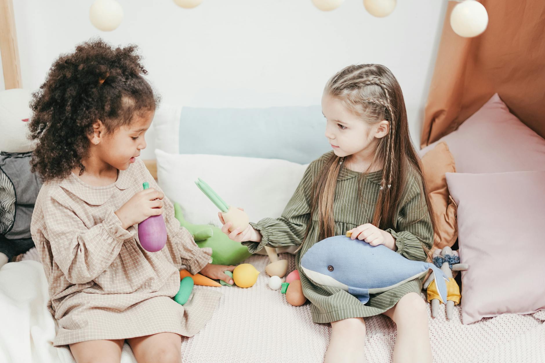 siblings sharing their toy to each other