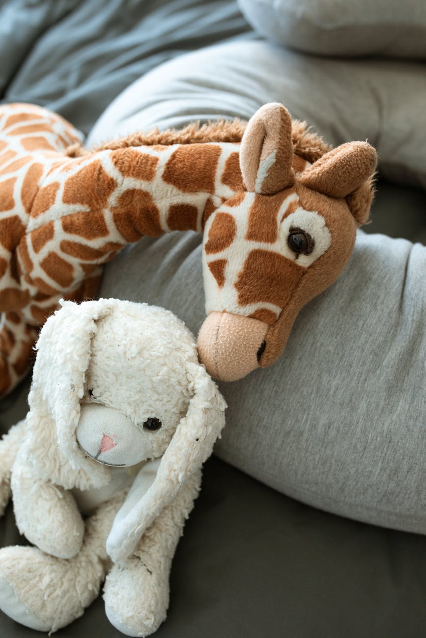 brown and white giraffe plush toy