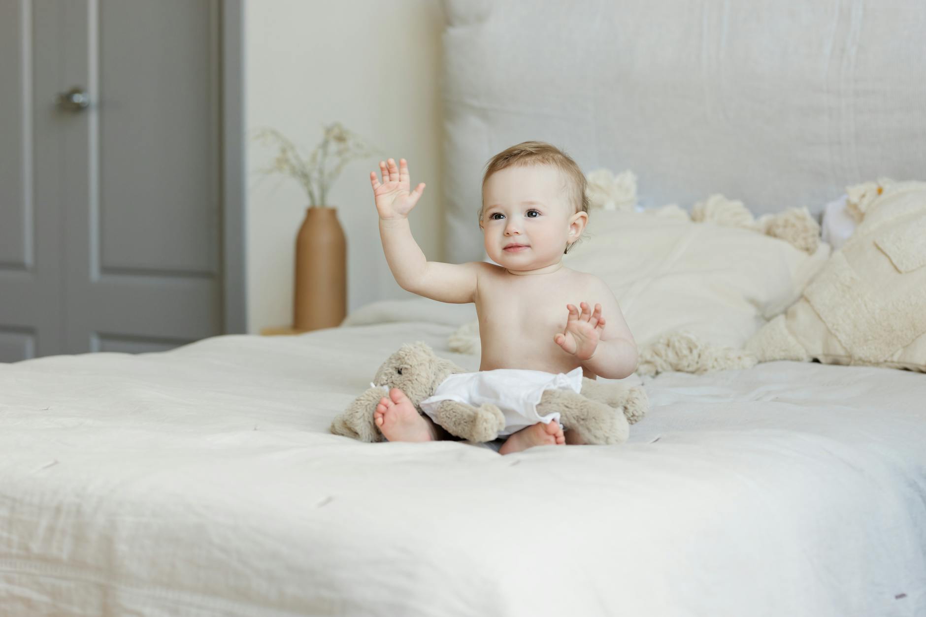 baby sitting on bed