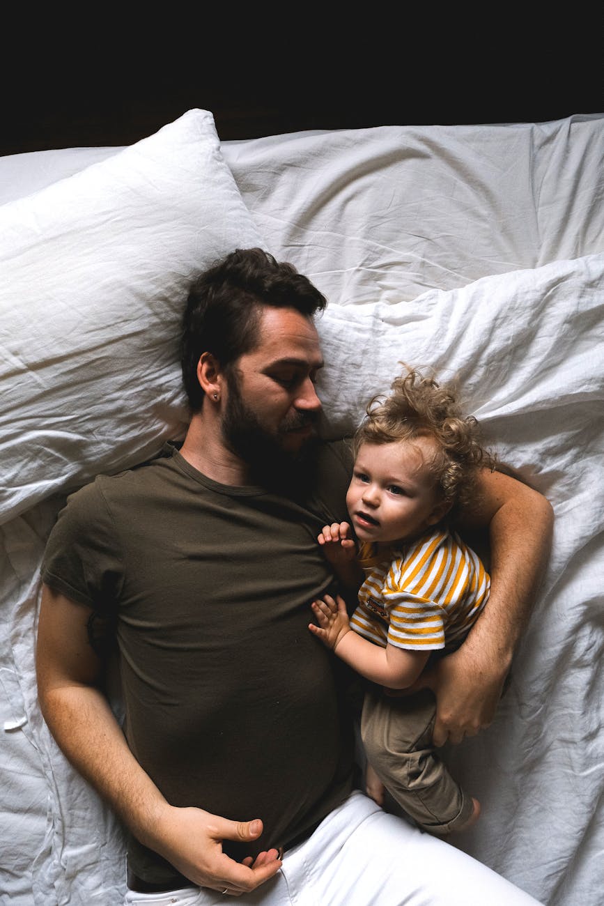 man and son lying in bed