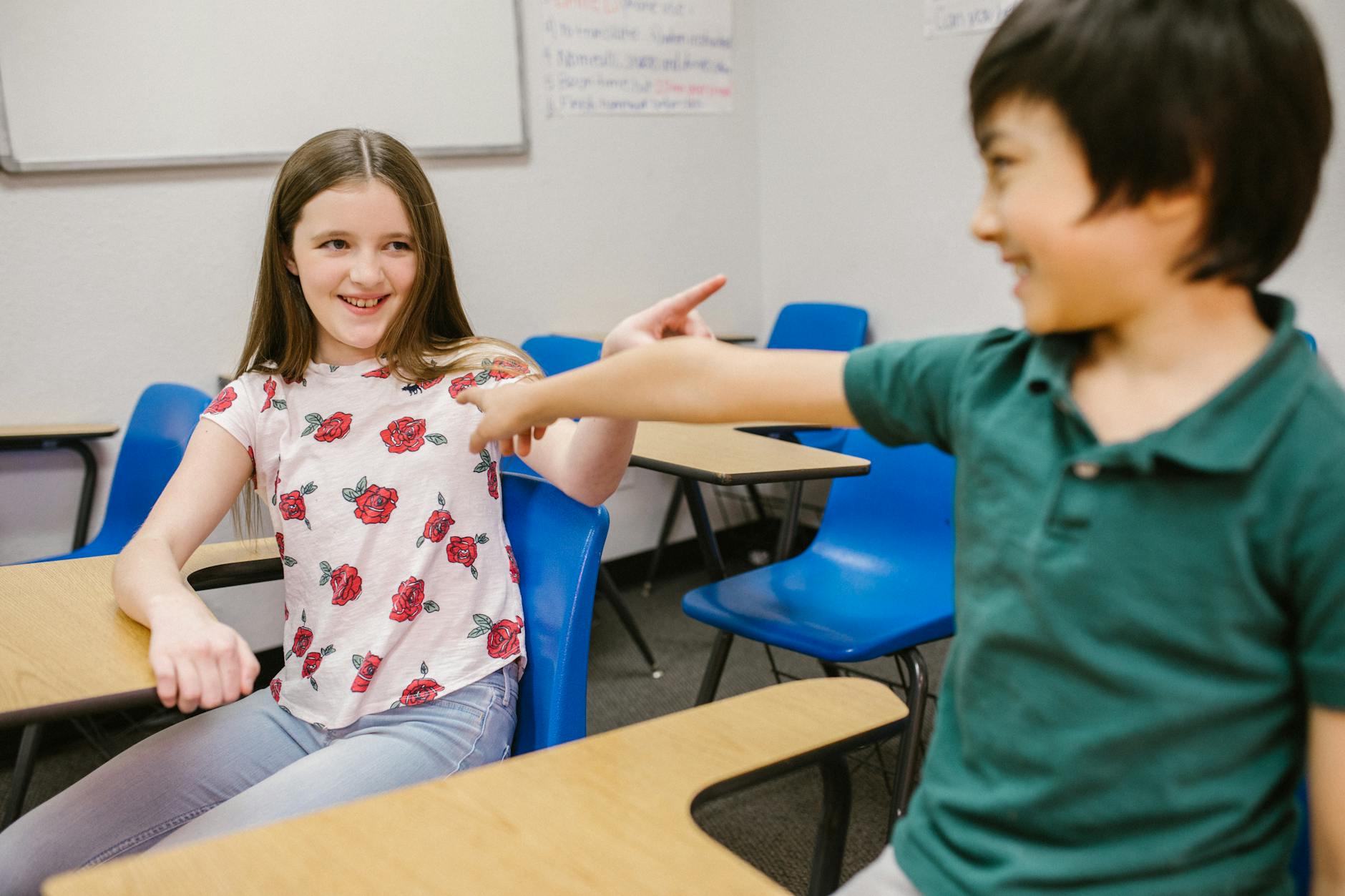 two kids pointing at each other