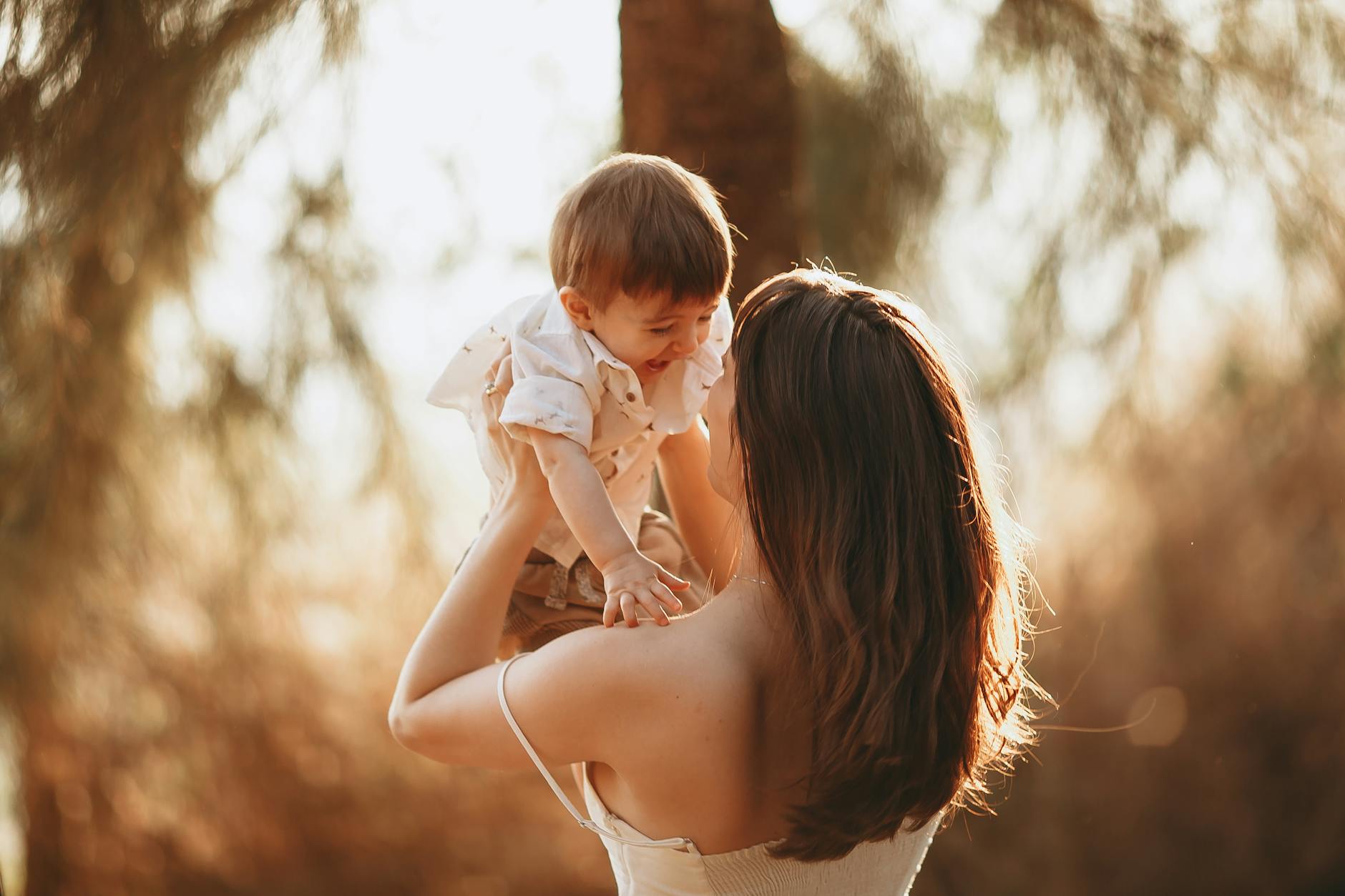 a woman carrying a young boy