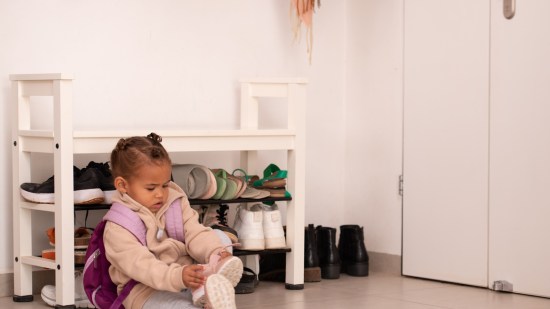 Niña poniéndose los zapatos