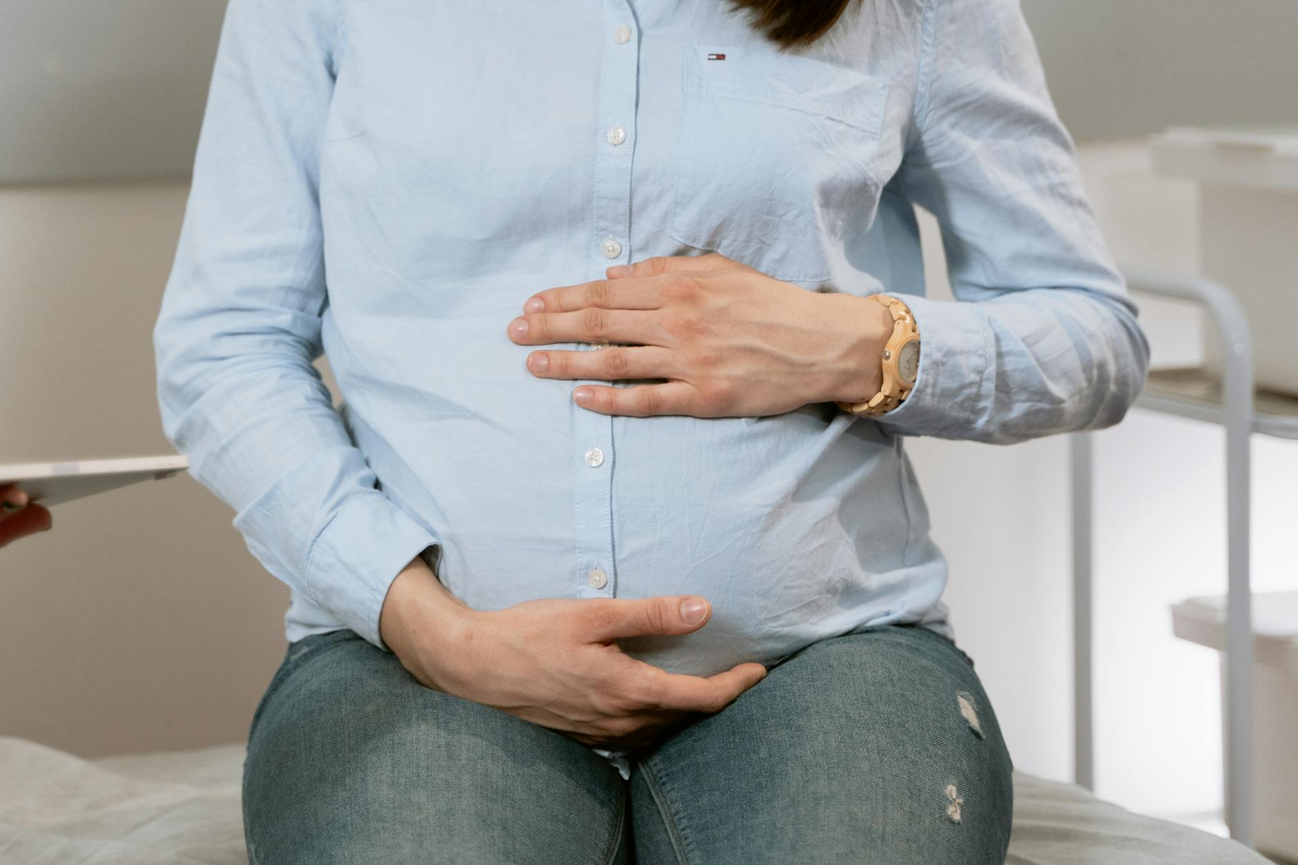 photo of person holding her stomach