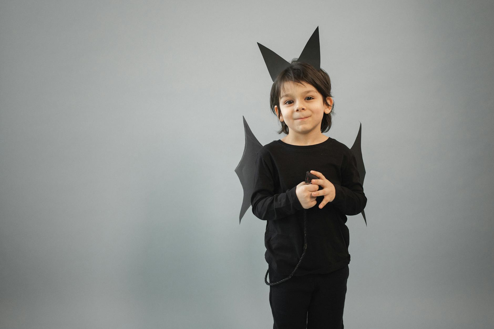 content boy in bat costume