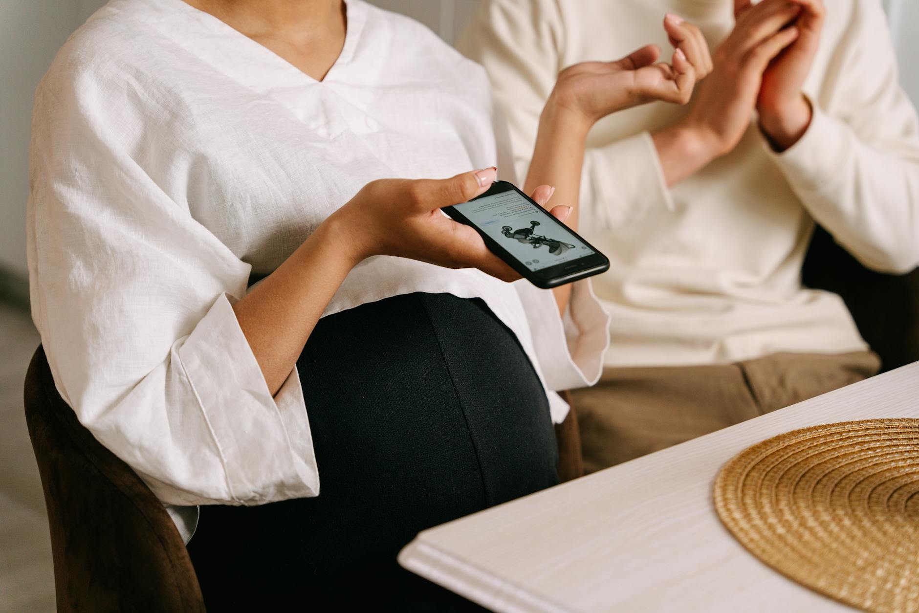 a pregnant woman holding a smartphone