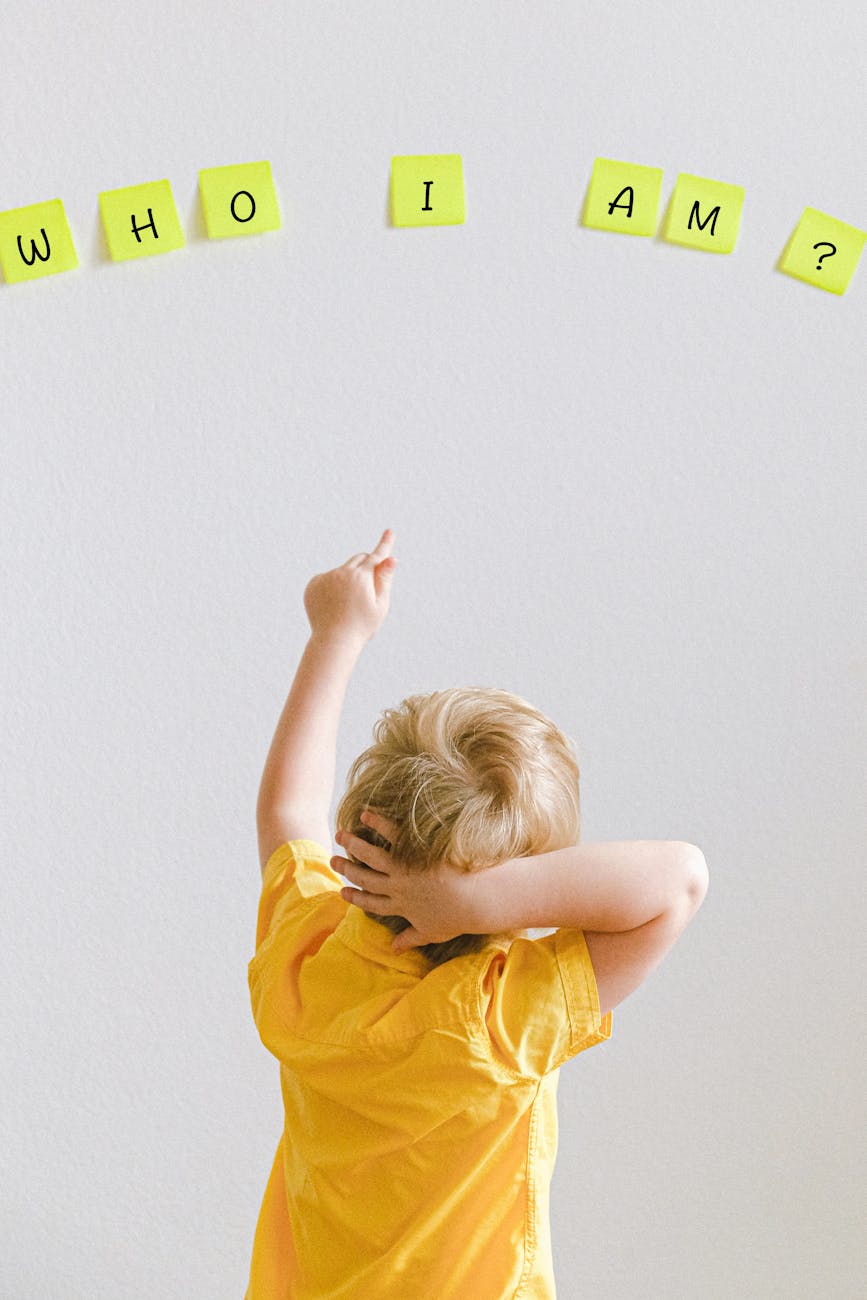 boy pointing at sticky notes on the wall