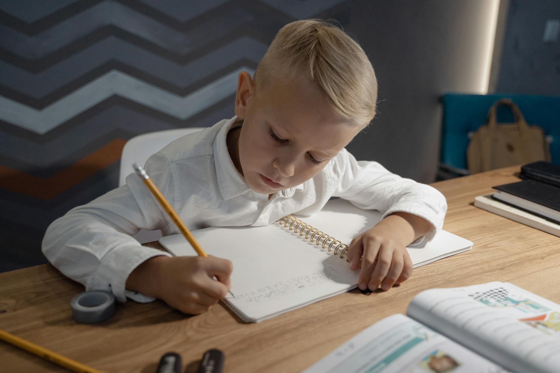 a kid writing on a notebook