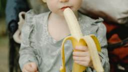 Niña comiendo un plátano