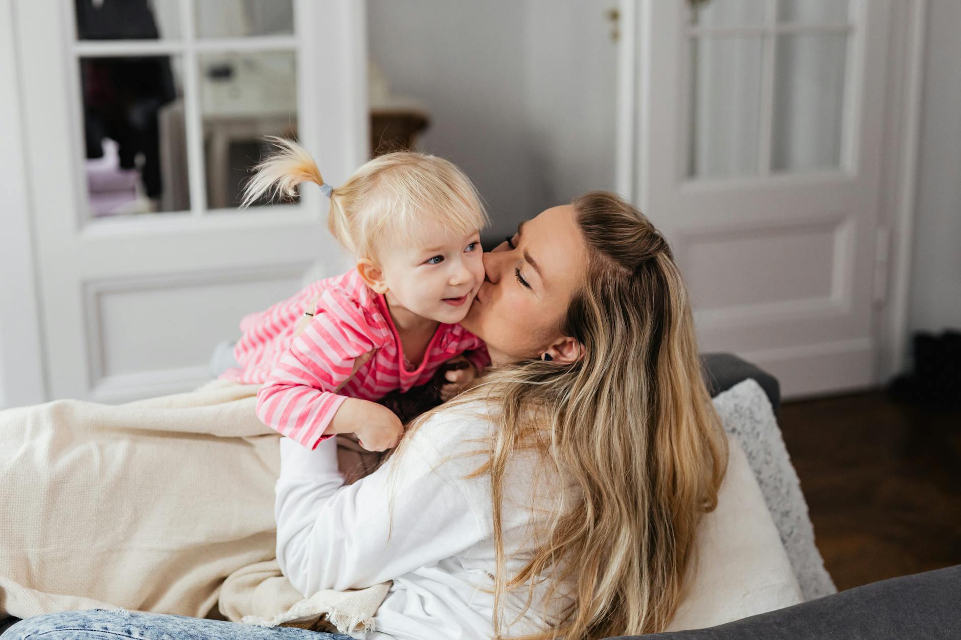 woman playing with daughter in living room