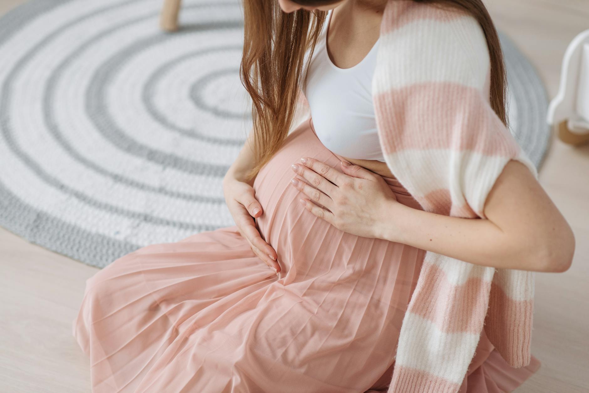 an expectant mother rubbing her pregnant belly