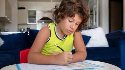 Niño, con un cuaderno de actividades