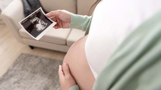 asian-pregnant-woman-hand-holding-ultrasound-image-belly-home-pregnancy-maternity-preparation-expectation-concept