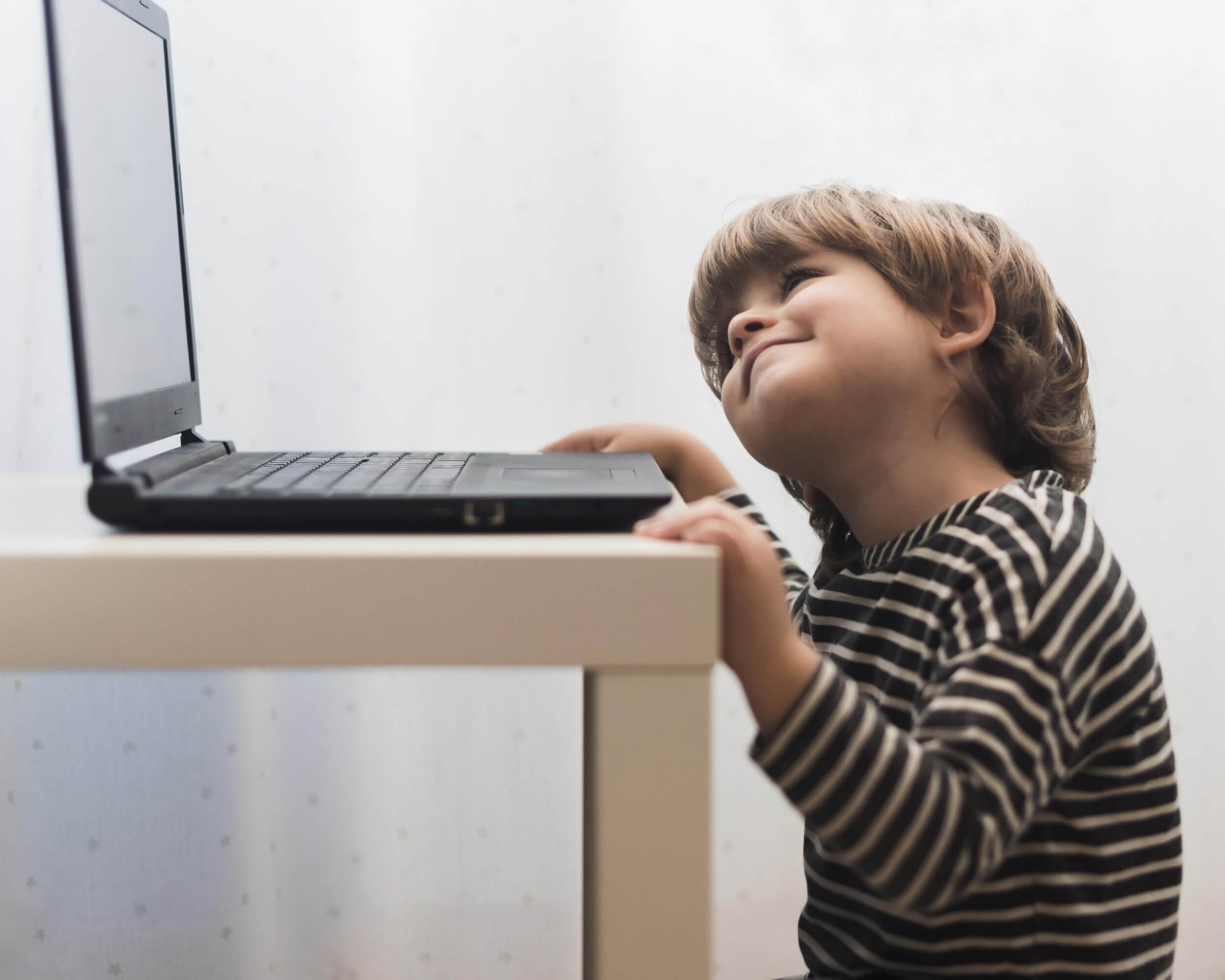 medium-shot-kid-looking-laptop