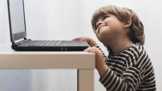 medium-shot-kid-looking-laptop