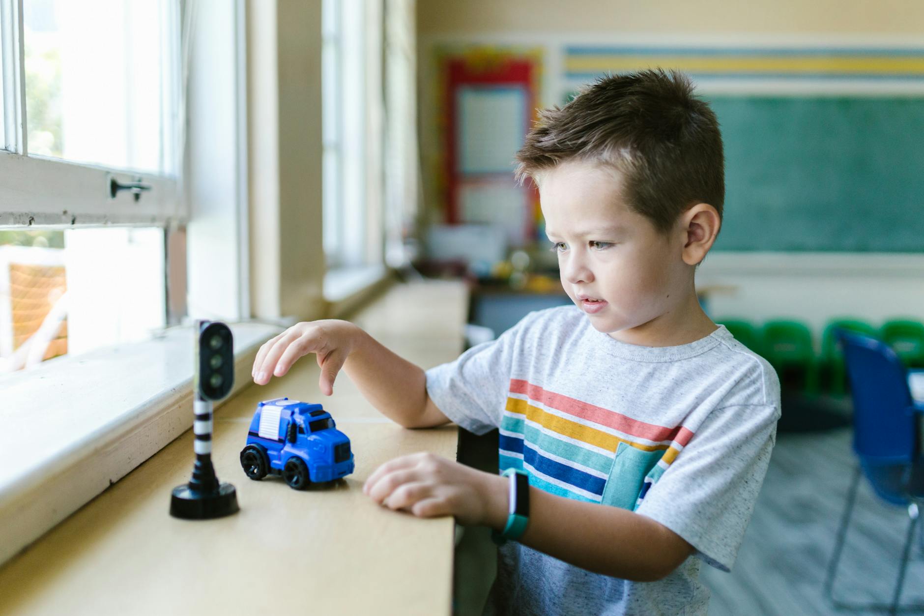 a boy playing with a toy car