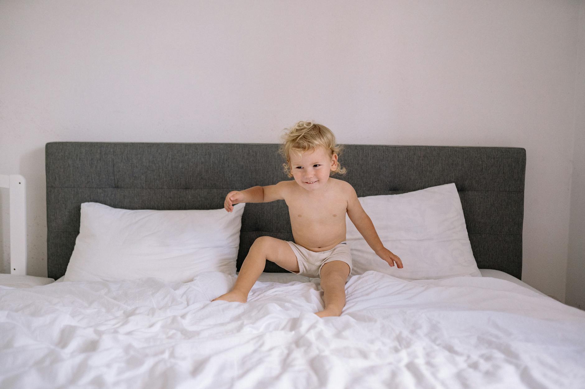 baby sitting on the bed