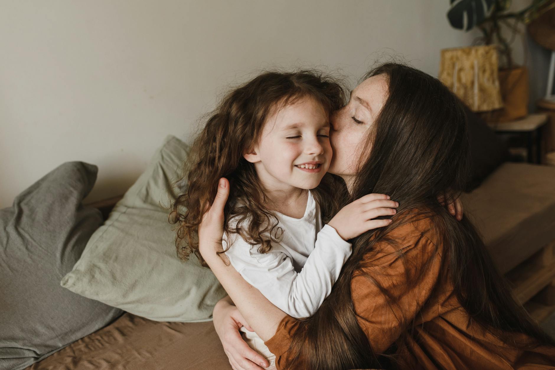 woman kissing a girl